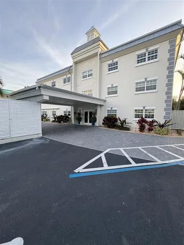 a view of a building with car parked