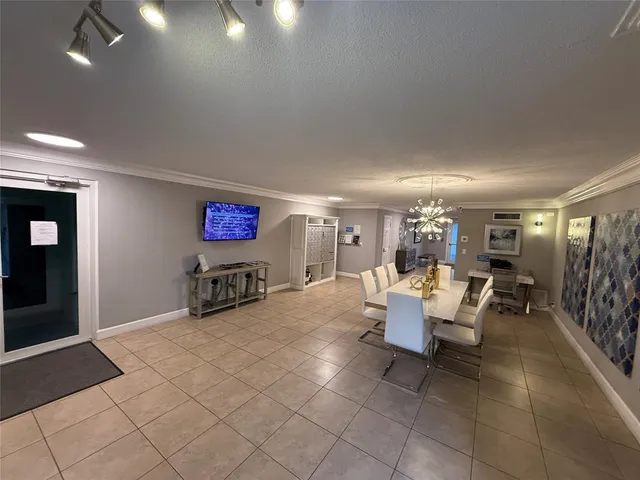 a living room with lots of furniture and chandelier