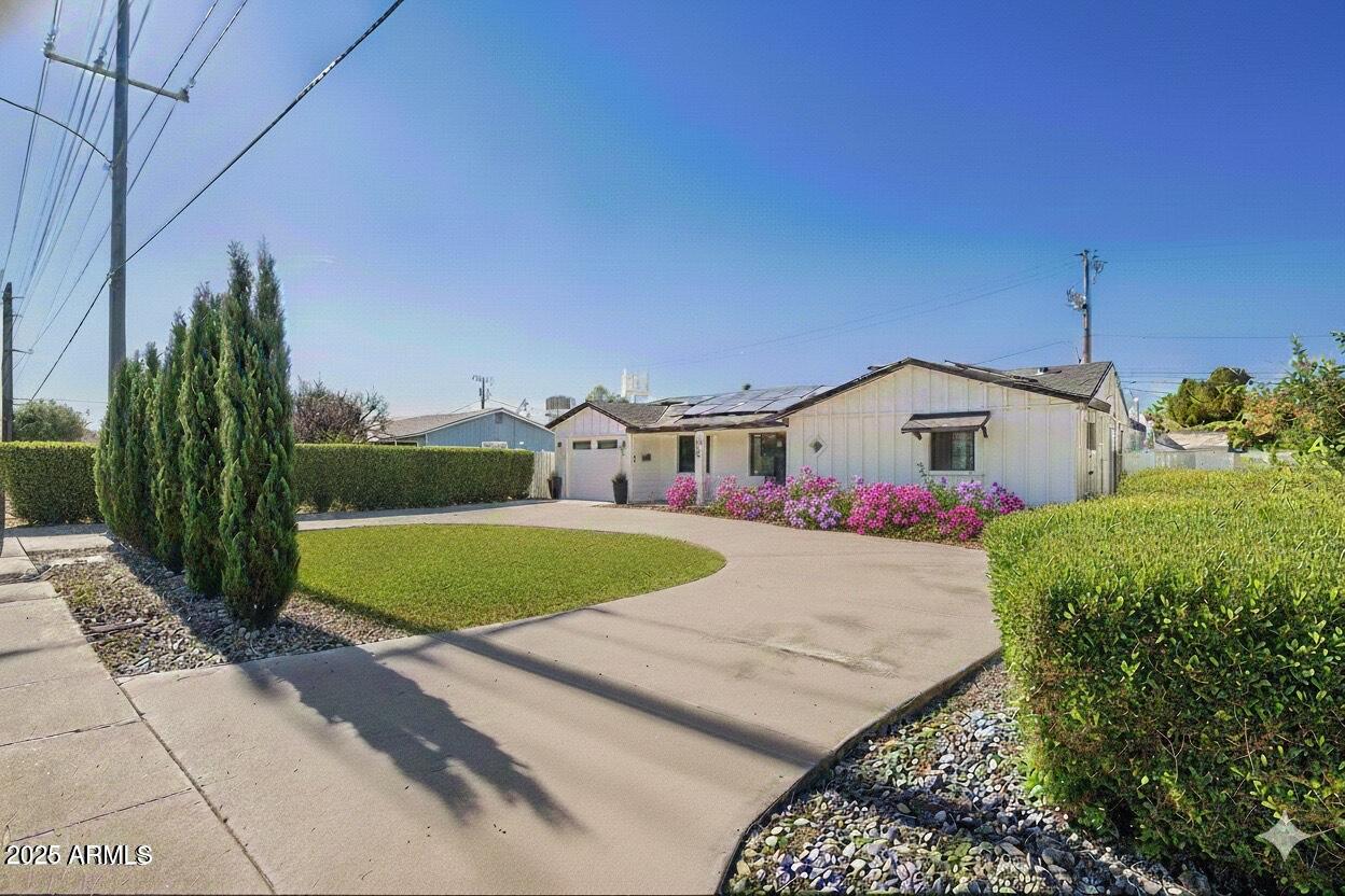 a front view of a house with garden