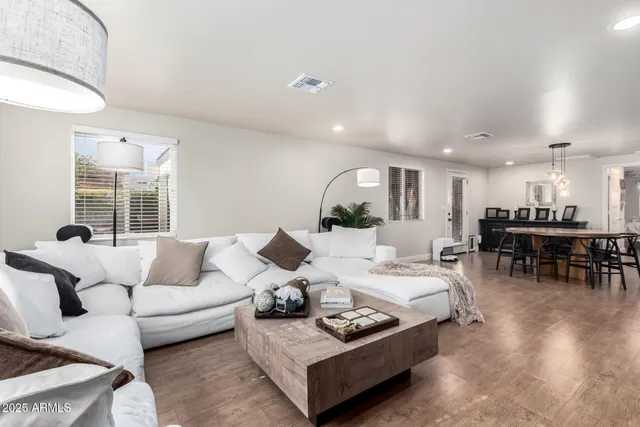 a living room with furniture and wooden floor
