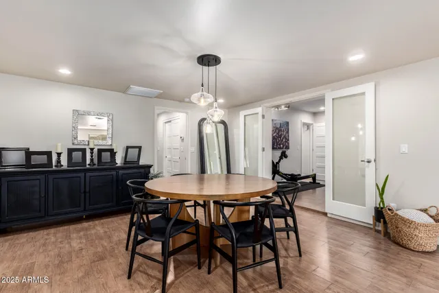 a view of a a dining room with furniture window and wooden floor