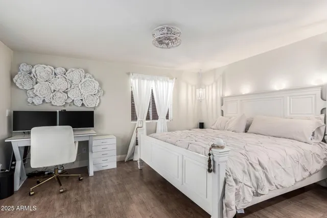 a bed room with a bed window and a chair