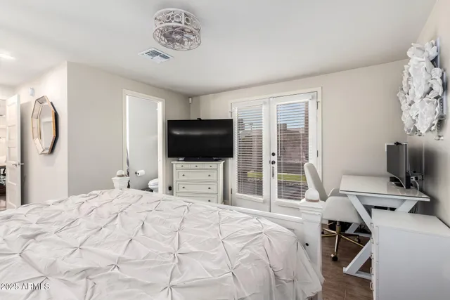 a bedroom with a bed and a flat screen tv