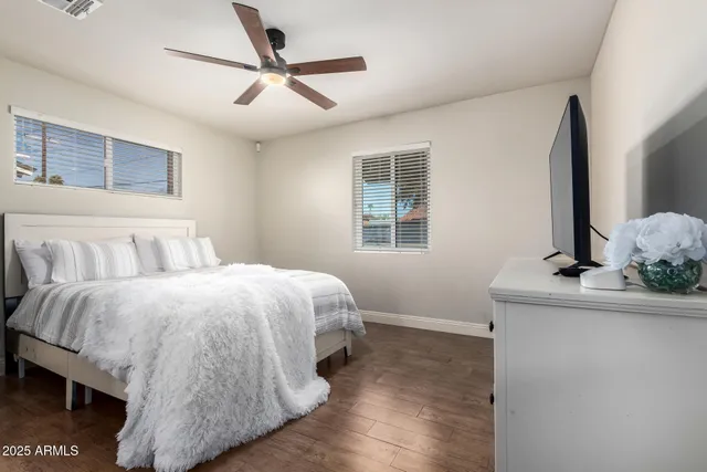 a bedroom with a bed and a flat screen tv