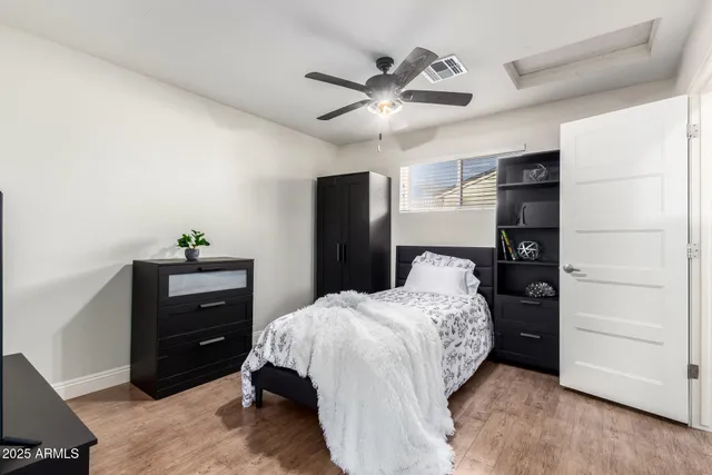 a bedroom with a bed and a dresser