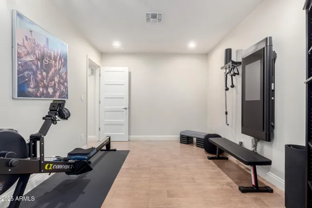 a room with gym equipment and a mirror