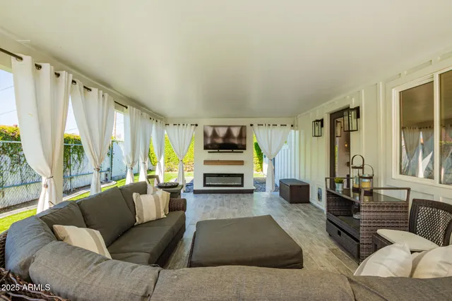 a living room with furniture and large windows