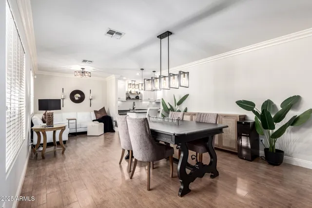 a view of a dining room with furniture and chandelier