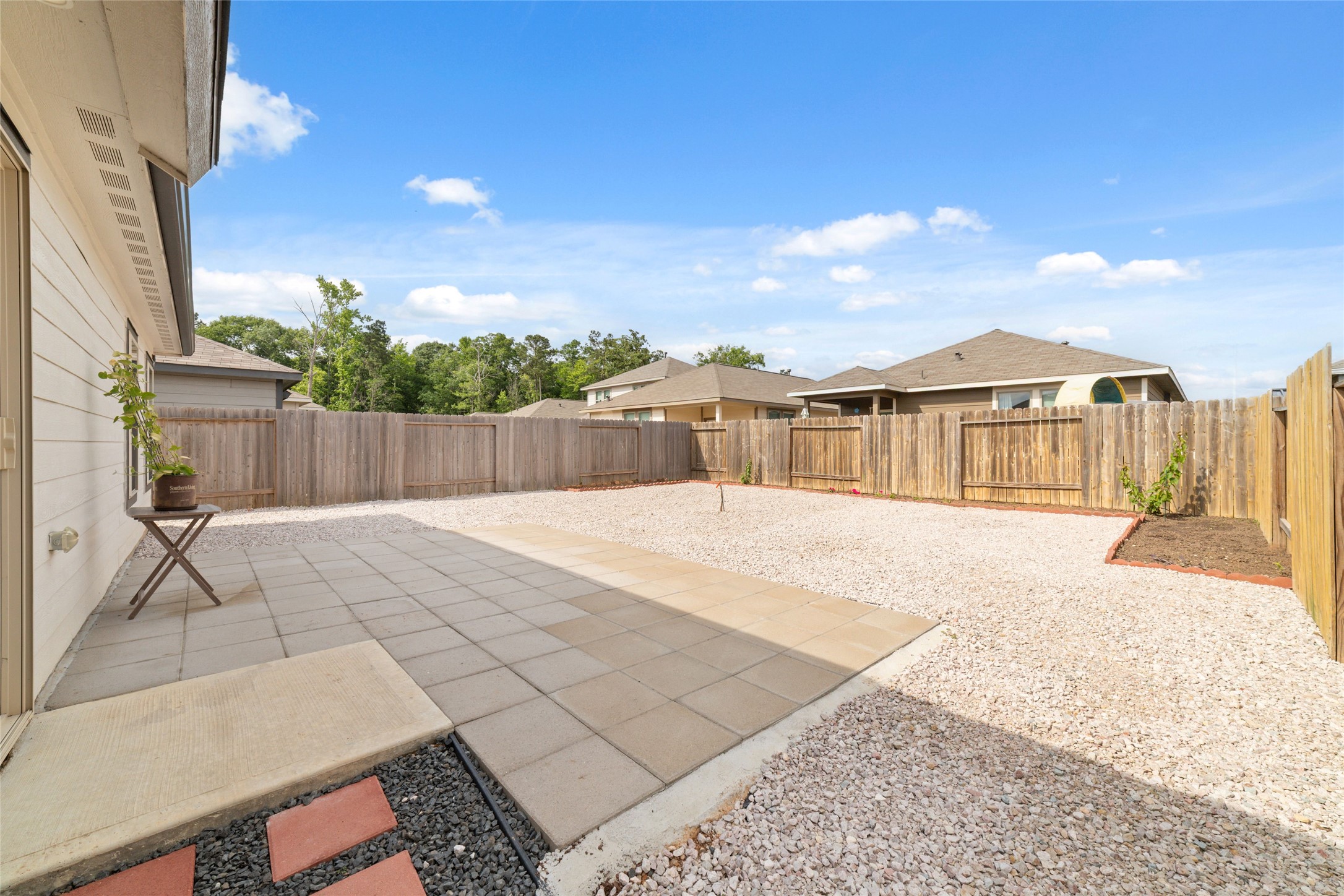 14232 Shasta Ridge Drive Conroe, TX 77303 - Photo 24 of 26 Private backyard with an extended patio and open space, perfect for outdoor seating and entertaining.