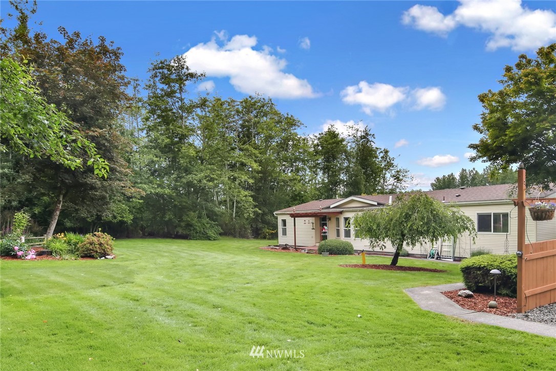 4030 Bay Road Ferndale, WA 98248 - Photo 2 of 36 a front view of a house with a garden