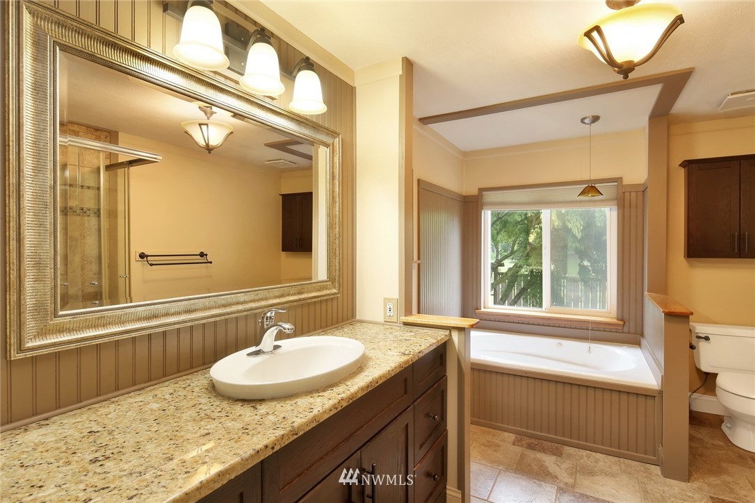 4030 Bay Road Ferndale, WA 98248 - Photo 12 of 36 a bathroom with a granite countertop sink and a mirror