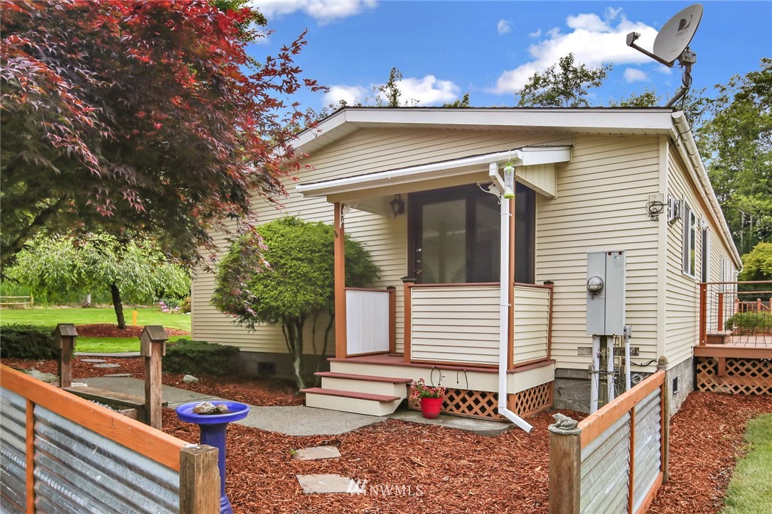 4030 Bay Road Ferndale, WA 98248 - Photo 23 of 36 a view of a white house with a sink and floor next to a yard
