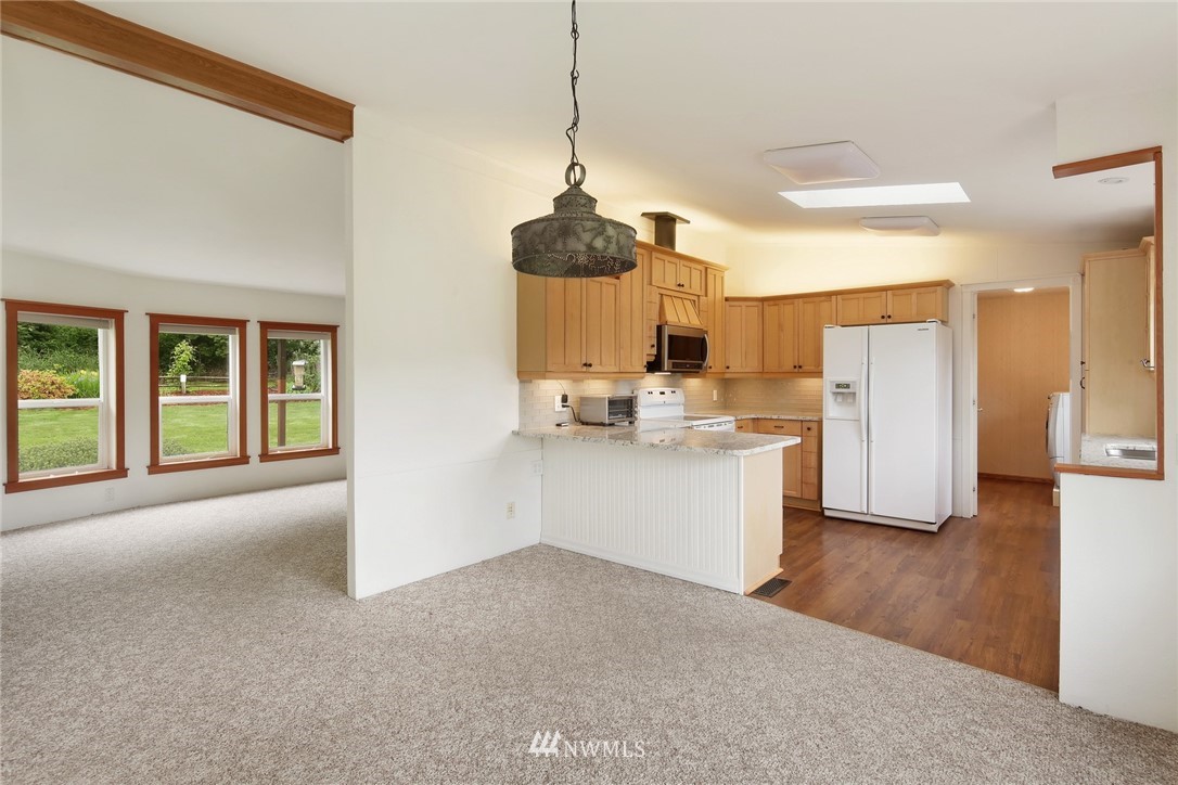 4030 Bay Road Ferndale, WA 98248 - Photo 7 of 36 a kitchen with a refrigerator and a stove top oven