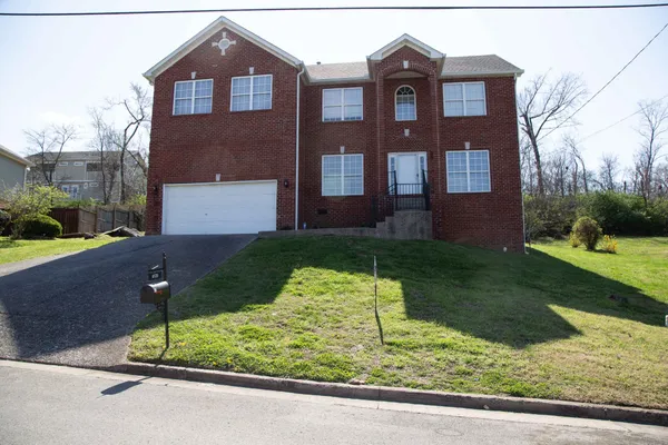 a brick house with a yard in front of it