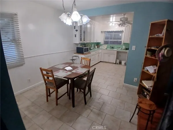 a dining room with furniture and chandelier