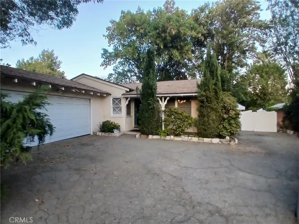 a view of a house with a yard and garage
