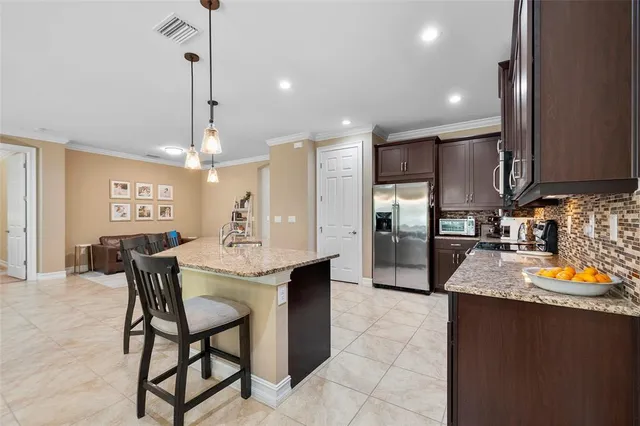 a large kitchen with a table and chairs
