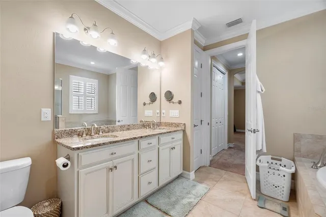 a spacious bathroom with a granite countertop sink mirror and a toilet