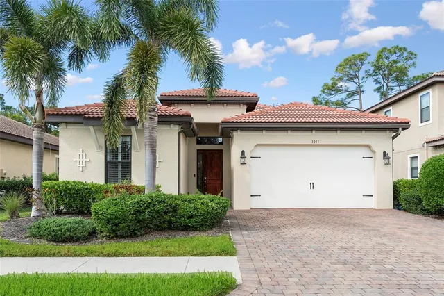 a view of a house with a yard and palm trees