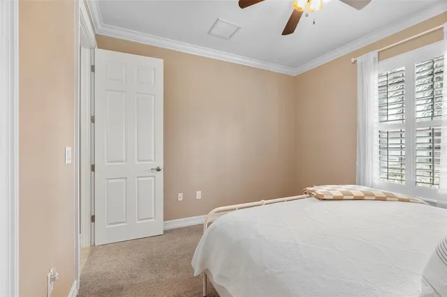 a bedroom with a bed and a ceiling fan