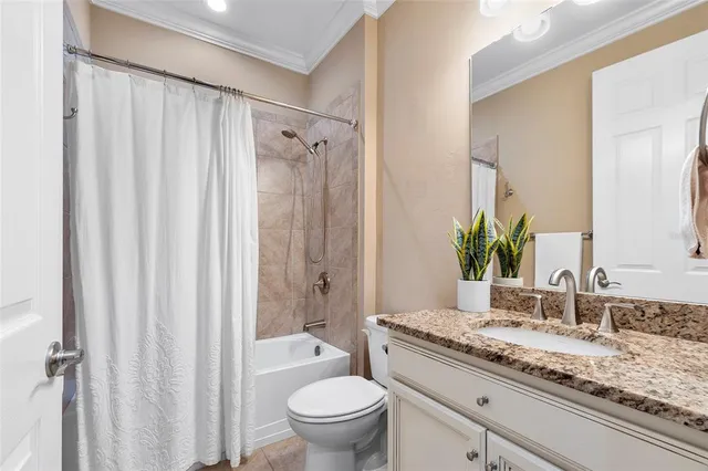 a bathroom with a granite countertop sink toilet and a mirror
