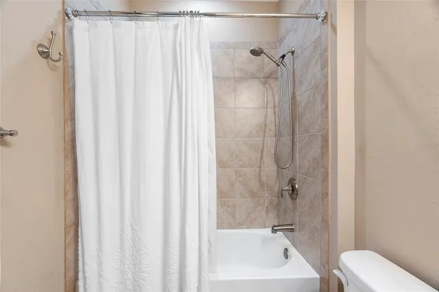 a bathroom with a shower curtain and a sink
