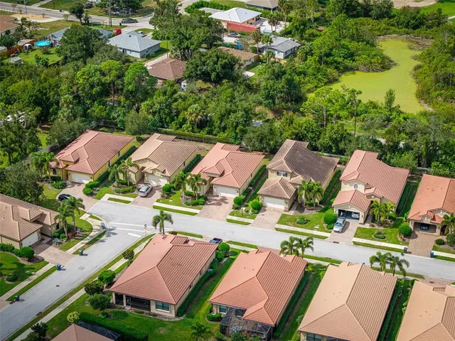 an aerial view of residential houses with outdoor space