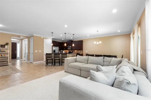 a living room with furniture and kitchen view
