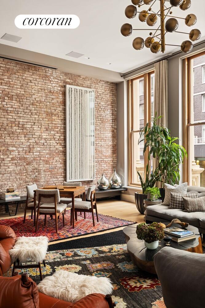 87 Leonard Street, Unit 2 Manhattan, NY 10013 - Photo 10 of 24 a living room with furniture and large windows