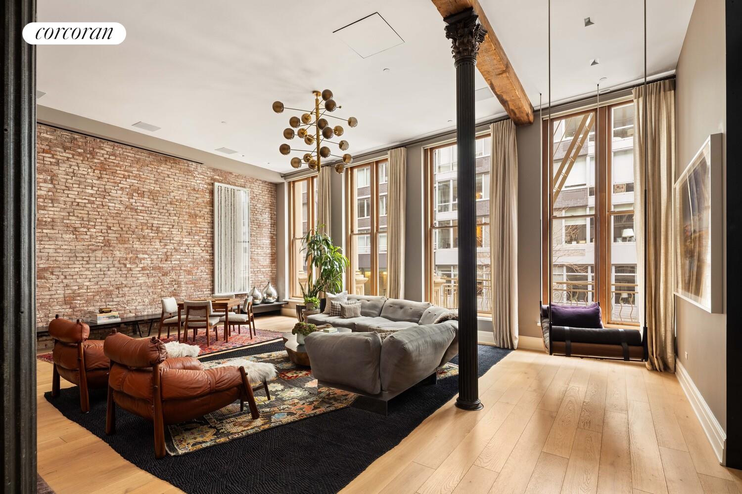 87 Leonard Street, Unit 2 Manhattan, NY 10013 - Photo 2 of 24 a living room with furniture and a large window
