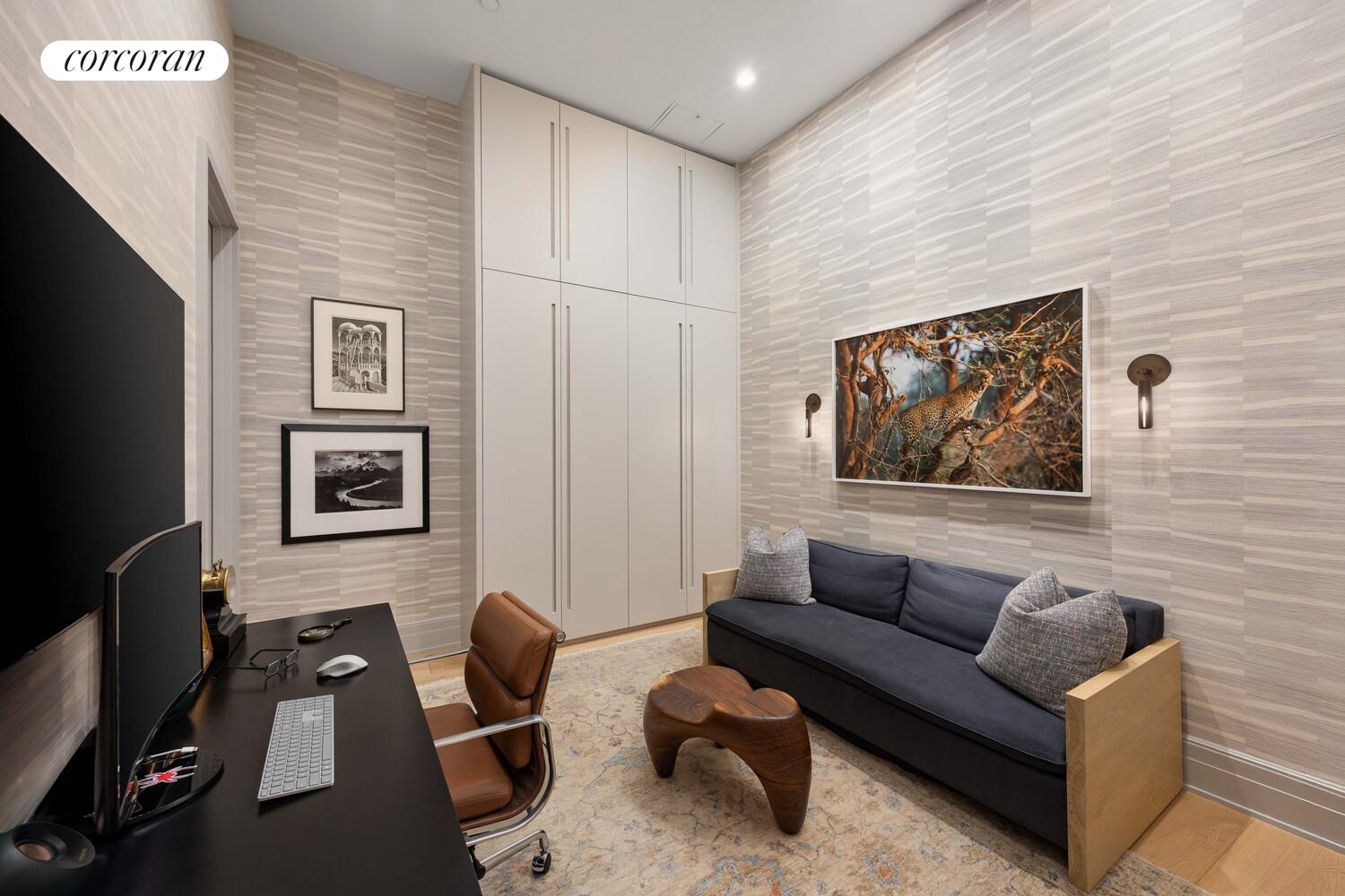 87 Leonard Street, Unit 2 Manhattan, NY 10013 - Photo 22 of 24 a living room with furniture and a flat screen tv