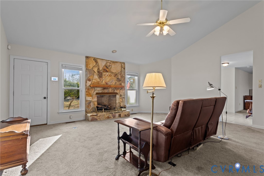 518 Rebel Ridge Road Colonial Heights, VA 23834 - Photo 14 of 44 a living room with furniture a fireplace and a chandelier