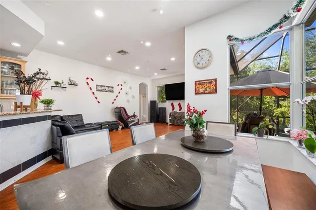 a kitchen with stainless steel appliances kitchen island granite countertop a refrigerator and a sink