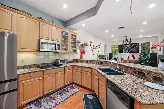 a room with lots of potted plants and a chandelier