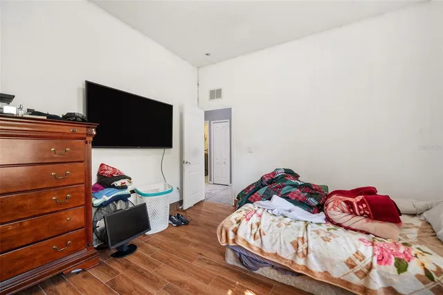a bedroom with furniture and a wooden floor
