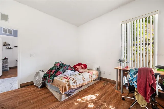 a bedroom with furniture and a flat screen tv