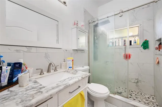 a bathroom with a sink toilet and shower