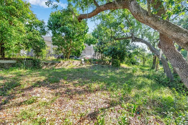 a view of a patio with table and chairs under an umbrella