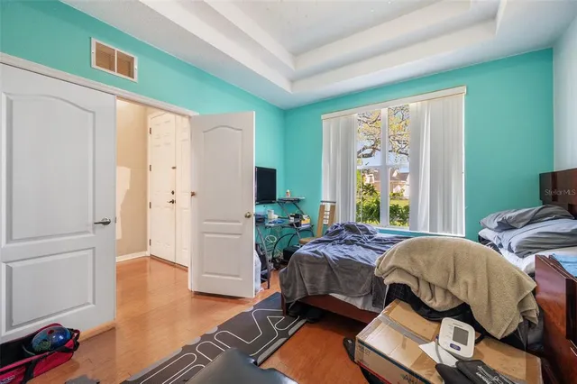 a bedroom with furniture and a book shelf