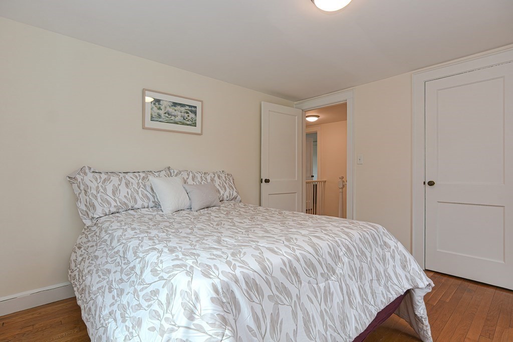 95 Southbourne Road Boston, MA 02130 - Photo 14 of 29 a large bed sitting in a bedroom and a table