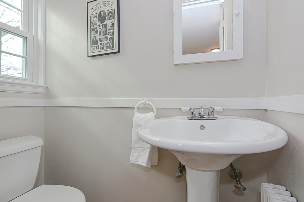 95 Southbourne Road Boston, MA 02130 - Photo 10 of 29 a bathroom with a sink a toilet and mirror