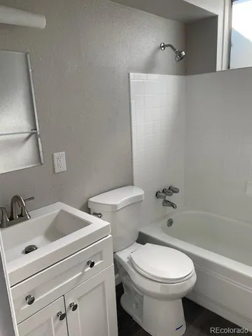 a white toilet sitting next to a bathroom sink