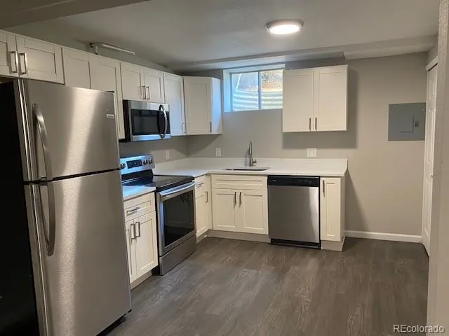 a kitchen with stainless steel appliances a refrigerator sink and microwave