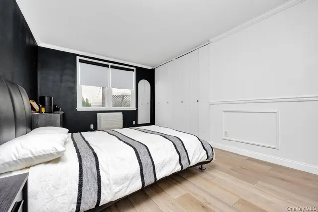 a bedroom with a bed and window