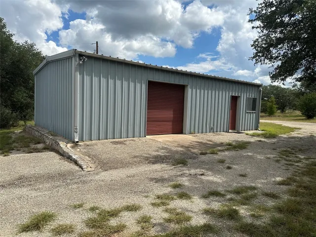 a view of a house with a wooden fence