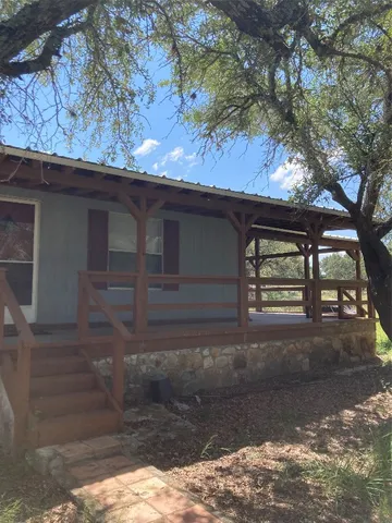 a view of a house with a tree