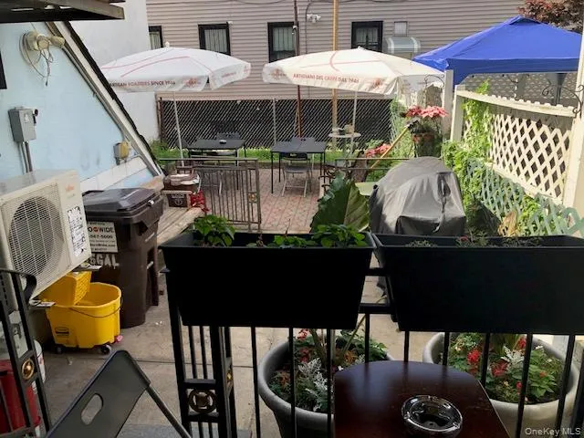 a view of a balcony with chairs and a potted plant