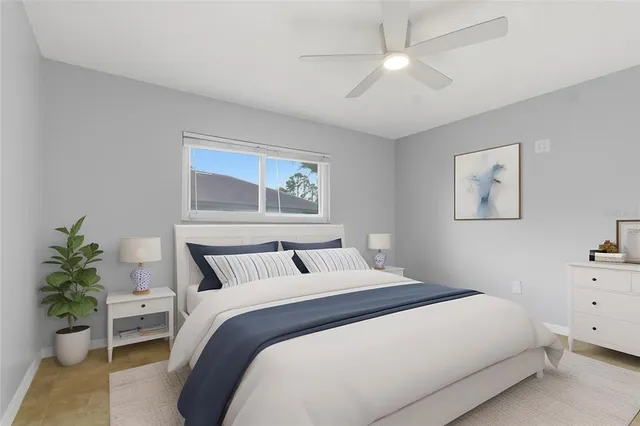 a bedroom with a large bed and a chandelier