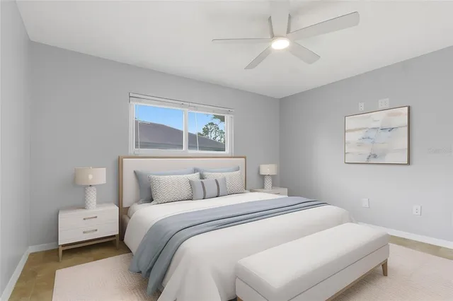 a bedroom with bed and a chandelier