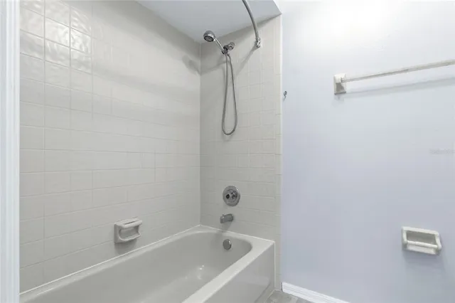 a bathroom with a bath tub with a shower